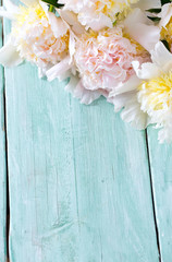 peonies on wooden surface