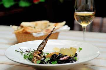 Tasty Italian food.
Fettuccine with the addition of cuttlefish ink sauce and pike caviar on a white plate.
Restaurant supply.
