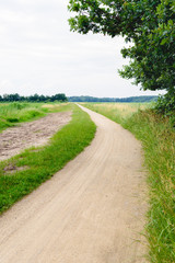 Fototapeta na wymiar Winding dirt road through a rural area