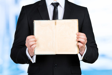 Unrecognizable businessman holding a book closeup