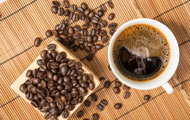 Coffee cup and beans on wooden,top view