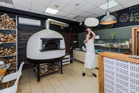 Young chef making traditional pizza dough