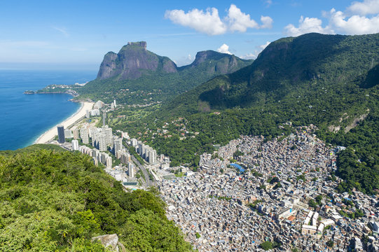 Scenic skyline view from above Sao Conrado Beach with Pedra da Gavea mountain and the favela community of Rocinha in Rio de Janeiro, Brazil