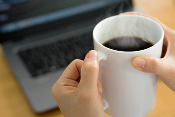 Businesswoman using tablet computer-net book and drinking coffee