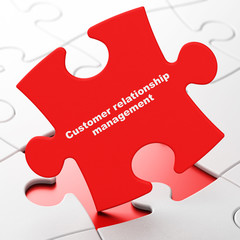 Advertising concept: Customer Relationship Management on puzzle background