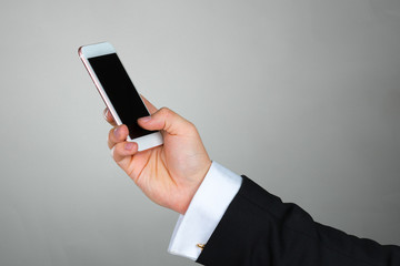 Close up of a businessman using mobile smart phone