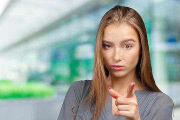 smiling young woman pointing