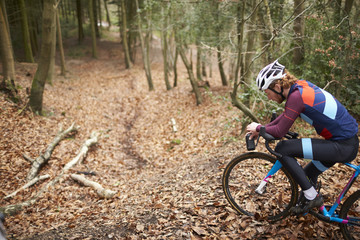 Cross-country cyclist resting on bike with water bottle