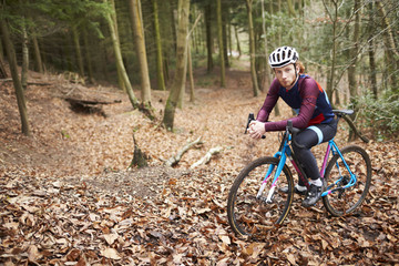 Portrait of man cross-country cycling in a forest