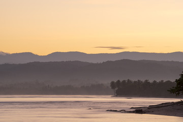 Beach coast landscape with trees and hills