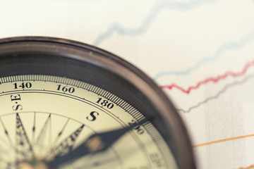 A compass on charts. A direction of success