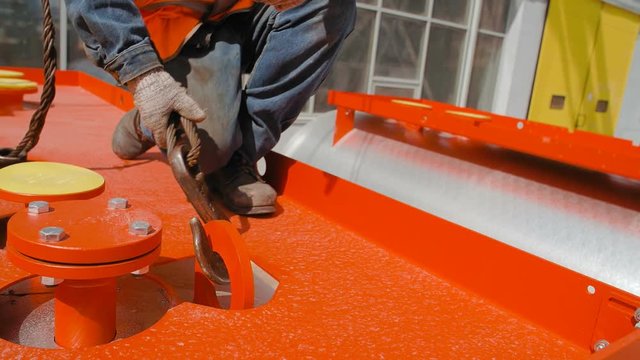 Worker Catches Crane Hook