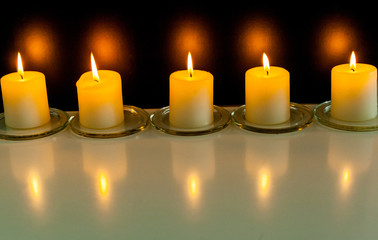 closeup to burning candles in darkness