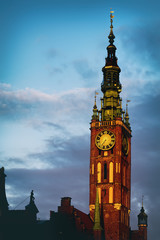 Gothic clock tower in european city in the evening.