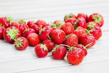 Fresh beautiful strawberries in the shape of a heart on a white