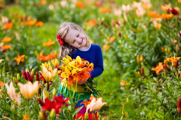 Little girl picking lilly flowers