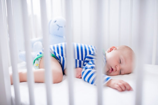 Sleeping Baby Boy In White Crib