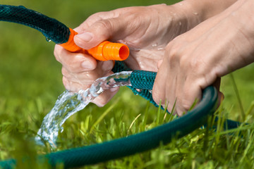 hands  connecting garden hoses for irrigation