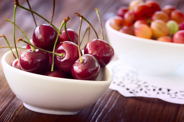 Fresh cherries in bowl on table. Fresh cherries in pot on the ta