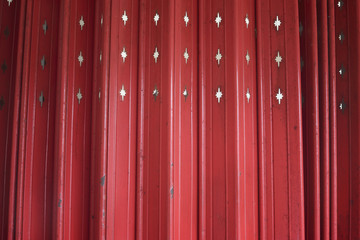 close up Antique slide steel door, Old style of closed red steel door. little Rusty on steel door. Folding steel door texture pattern and background. Dark edged.
