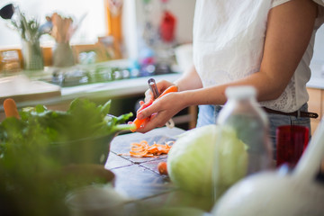 Woman cooking in kitchen with ingredients around her