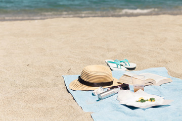 Typical beach gear of beauty products and care with female things for day in summer