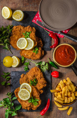 Schnitzel with fries, salad and herbs