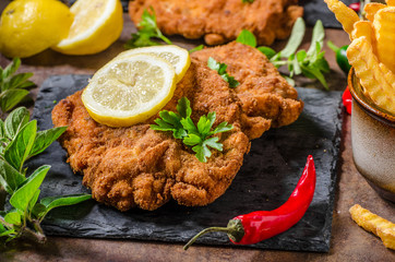 Schnitzel with fries, salad and herbs