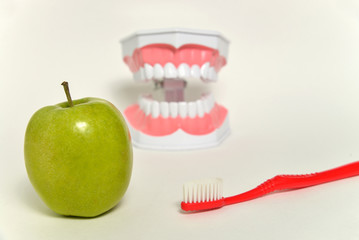 toothbrush and green apple, dental care concept