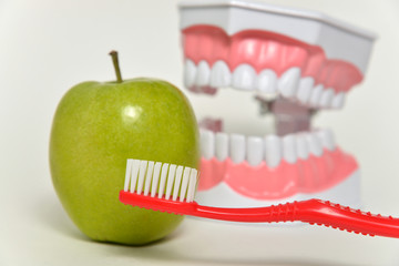 toothbrush and green apple, dental care concept