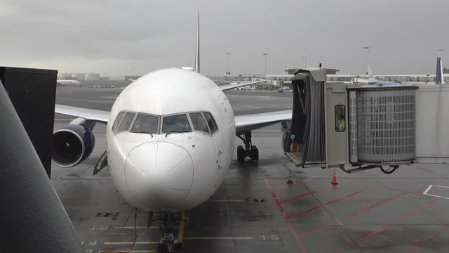 Movable Jet bridge connecting to arrived airplane. Shot in 4k