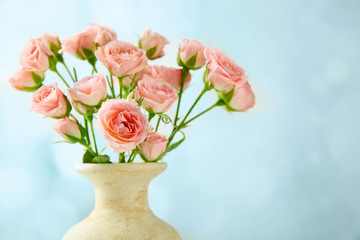 Vase with fresh roses, closeup