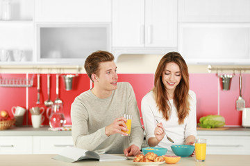 Obraz na płótnie Canvas Couple having breakfast in kitchen