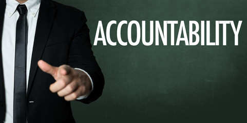 Business man pointing with the text: Accountability