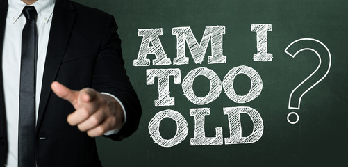 Business man pointing with the text: Am I Too Old? - obrazy, fototapety, plakaty