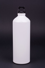 White aluminum water bottle on dark background