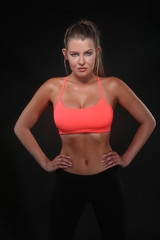 Naklejka premium Beautiful Woman Wearing Sexy Workout Clothing on Black
