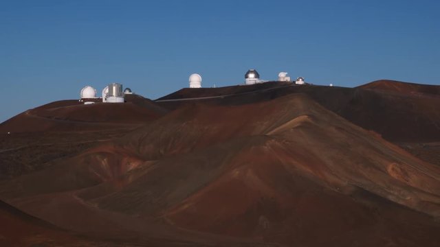 Past cinder cones on Mauna Loa with observatory in background. Shot in 2010.