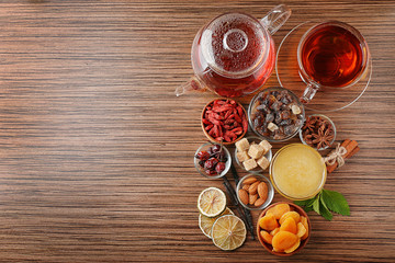 Tea composition on wooden background, flat lay