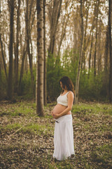 Pregnant woman in forest