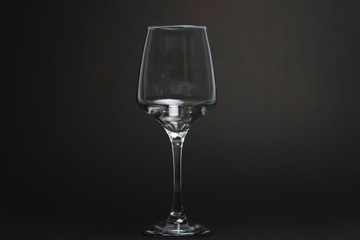 Composition with empty wine glasses on black background