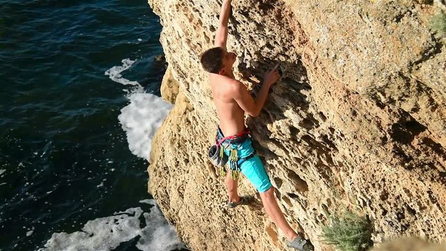 Extreme climber climbing on a rock
