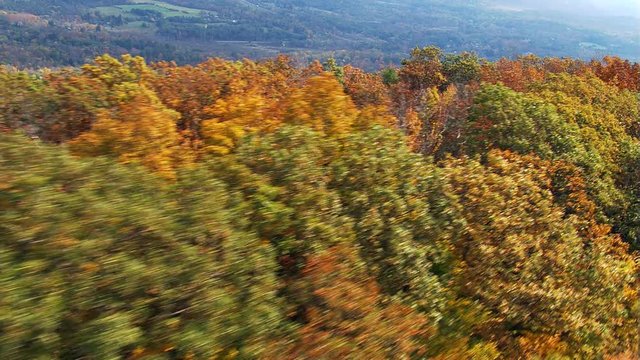 Low flight along wooded ridge in fall colors