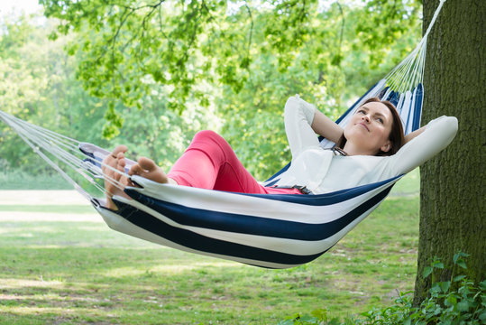 Woman Relaxing In Hammock