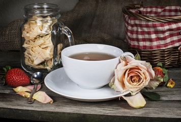 Cup of tea on vintage wooden board