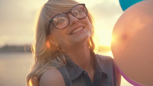 Happy girl at sunset with gel balls. RAW video record.