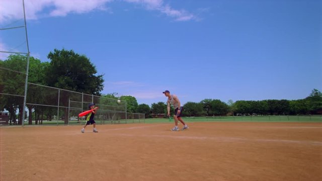 Son playing baseball with Dad in slow motion