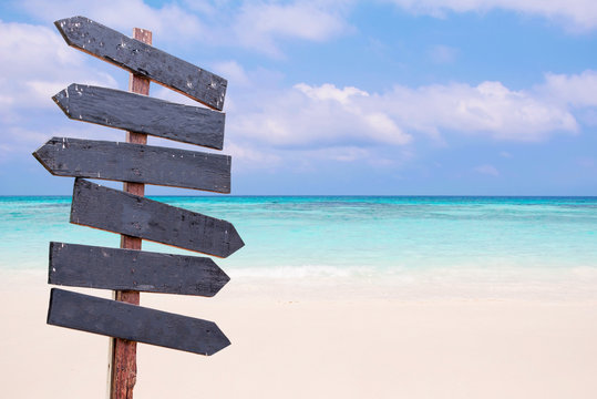 Wood Signs On The Beach. Sea And Blue Sky Background