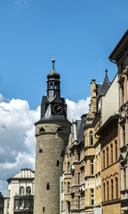 Naklejka premium ancient clock tower in the old city on sky background