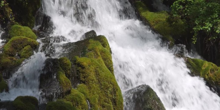 Waterfall among mossy boulders